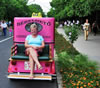 Lucy on the back of a very pink taxi!